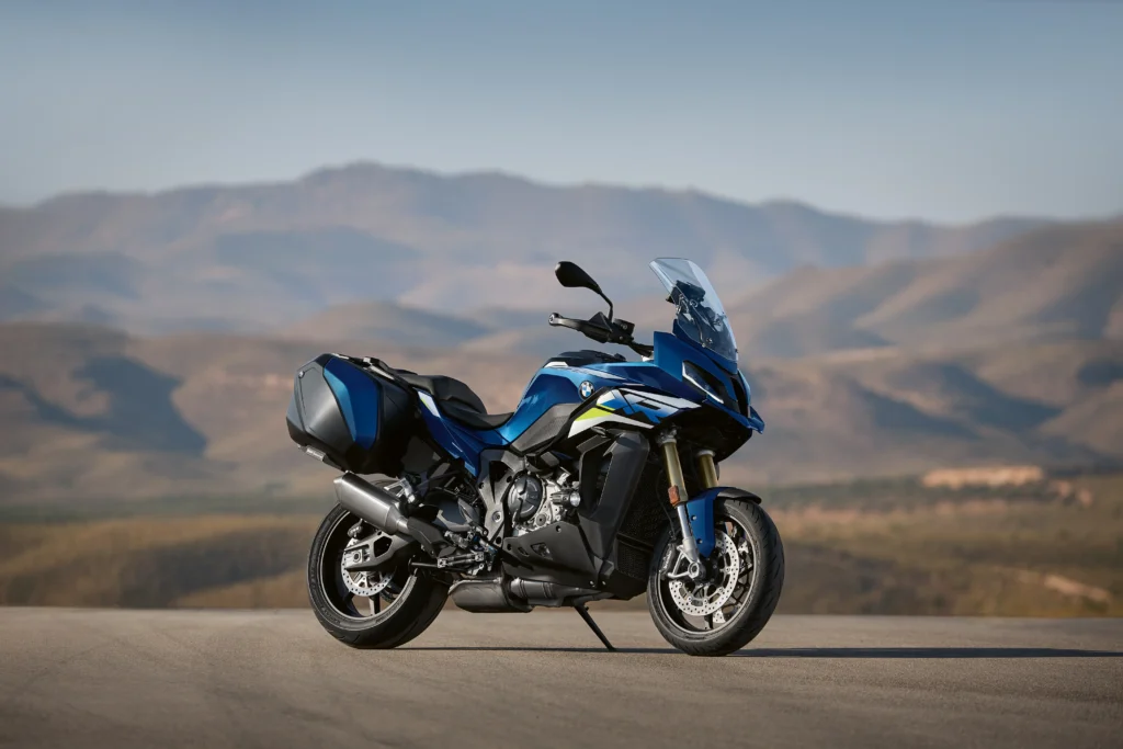 BMW S 1000 XR on an open road, providing excellent stability and power, ideal for two-up sport touring with a passenger.