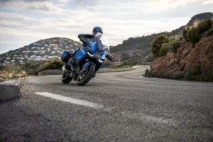 2026 Tourer of the Year - Blue BMW R 1300 RT luxury touring motorcycle on a coastal road - Best 2026 Touring Motorcycles